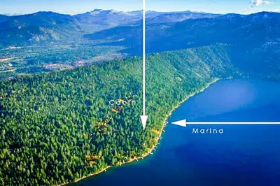 an island in the middle of a body of water at The Cherry Leaf Lodge & Retreat on Fallen Leaf Lake in Fallen Leaf