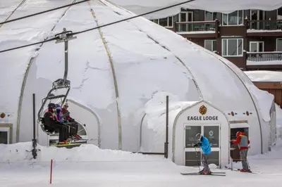 a group of people on a ski lift in a igloo at Wildflower 55 in Mammoth Lakes