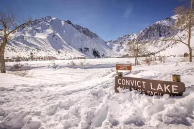 a sign in the snow in front of a mountain at Wildflower 55 in Mammoth Lakes
