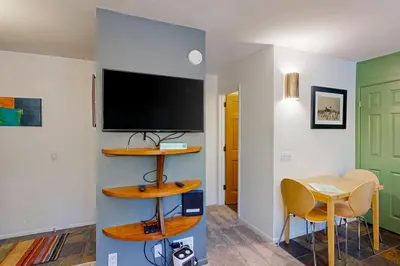 a living room with a tv and a table with chairs at La Vista Blanc 39 in Mammoth Lakes