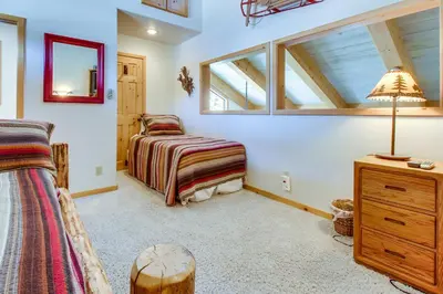 a bedroom with a bed and a desk and a lamp at Val D'Isere 45 in Mammoth Lakes