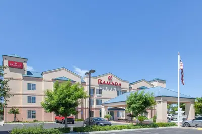 a hotel with a sign on the front of it at Ramada by Wyndham Fresno Northwest in Fresno