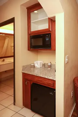 a kitchen with a counter and a microwave at Ramada by Wyndham Fresno Northwest in Fresno