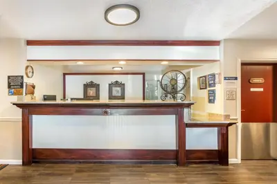 a bar in a room with a mirror at Best Western Luxury Inn in Tracy