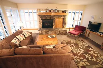 a living room with a couch and a fireplace at Silver Bear # 20 in Mammoth Lakes