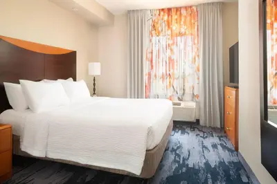 a hotel room with a large bed and a window at Fairfield Inn & Suites by Marriott Selma Kingsburg in Kingsburg