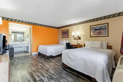 a hotel room with two beds and a television at Knights Inn Madera in Madera