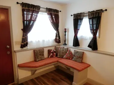 a bench in a room with two windows at NEW CHARMING 2 BEDROOMS UNIT CLOSE TO EVERYTHING in Oakhurst