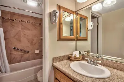 a bathroom with a sink and a toilet and a mirror at South Lake Tahoe Resort - Steps to Beach & Close to Heavenly in South Lake Tahoe
