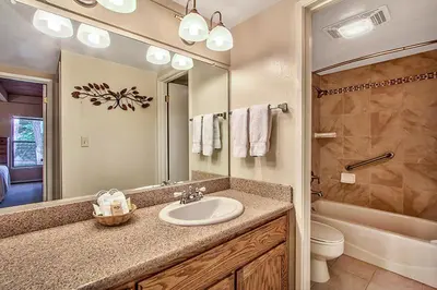 a bathroom with a sink and a toilet and a mirror at South Lake Tahoe Resort - Steps to Beach & Close to Heavenly in South Lake Tahoe