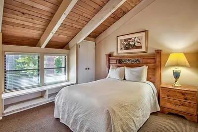 a bedroom with a white bed and a window at South Lake Tahoe Resort - Steps to Beach & Close to Heavenly in South Lake Tahoe