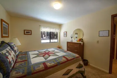 a bedroom with a bed and a dresser at Bruin's Den in Wawona