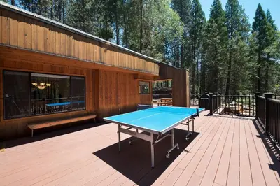 a ping pong table on the deck of a house at Bruin's Den in Wawona