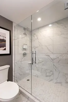 a bathroom with a glass shower with a toilet at J Resort in Reno