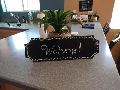 a kitchen counter with a sign that says welcome at Engvadonia Yosemite B and B in Mariposa