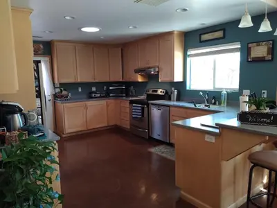 a kitchen with wooden cabinets and a counter top at Engvadonia Yosemite B and B in Mariposa