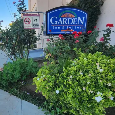 a sign for a garden firm with flowers at Garden Inn and Suites Fresno in Fresno