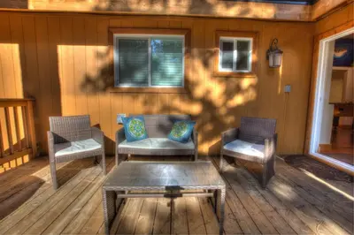 a porch with two chairs and a table on a house at Prestigious Home South Lake Tahoe in South Lake Tahoe