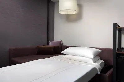 a bedroom with a bed and a couch at Visalia Marriott at the Convention Center in Visalia