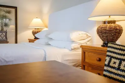 a bedroom with two beds and a table with a lamp at Appellation Lodi - Wine & Roses Resort and Spa in Lodi