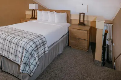 a hotel room with a large bed and two night stands at Mammoth Mountain Inn in Mammoth Lakes