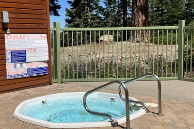 a jacuzzi tub sitting in front of a fence at Mountainback 47 in Mammoth Lakes