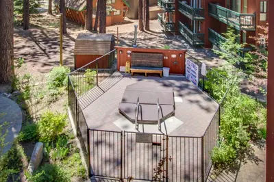 a patio with a bench and a table on it at Saddle Road Condo in Bijou Park