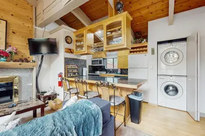 a kitchen and living room with a counter and a stove at Saddle Road Condo in Bijou Park