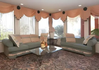 a living room with two couches and a table at Days Inn by Wyndham Gilroy in Gilroy