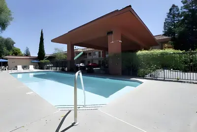 a swimming pool in front of a building at Days Inn by Wyndham Gilroy in Gilroy