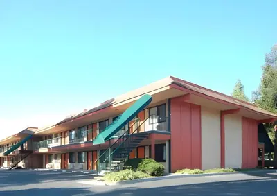 a building with a staircase in a parking lot at Days Inn by Wyndham Gilroy in Gilroy