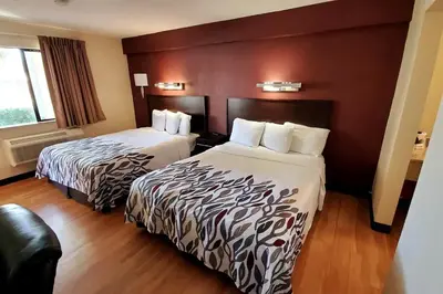 a hotel room with two beds and a window at California Inn and Suites, Rancho Cordova in Rancho Cordova