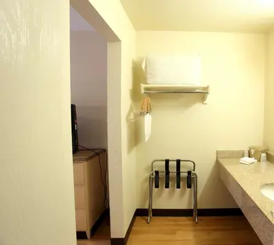 a bathroom with a sink and a towel rack at California Inn and Suites, Rancho Cordova in Rancho Cordova