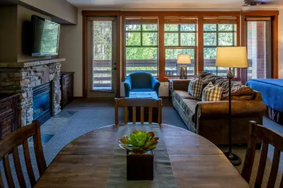 a living room with a couch and a table at The Village Lodge in Mammoth Lakes
