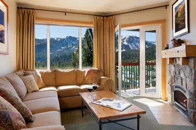 a living room with a couch and a fireplace at Juniper Springs Resort in Mammoth Lakes