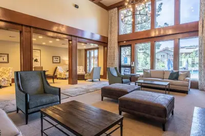 a living room with furniture and a large window at Juniper Springs Resort in Mammoth Lakes