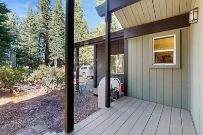 a front porch of a house with a grill at Lazy Bear Retreat in Mevers