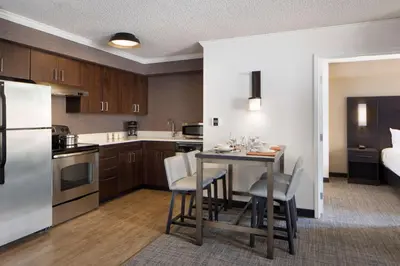 a kitchen and dining room with a table and chairs at Sonesta ES Suites Fresno in Fresno