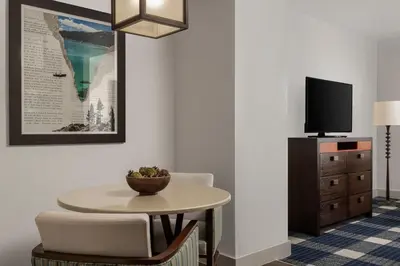 a room with a table and a chair and a tv at Marriott Grand Residence Club, Lake Tahoe in South Lake Tahoe