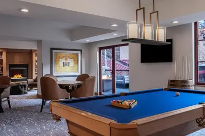 a living room with a pool table and a tv at Marriott Grand Residence Club, Lake Tahoe in South Lake Tahoe