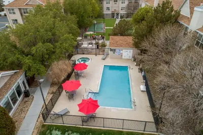 an overhead view of a swimming pool with umbrellas and chairs at Sonesta ES Suites Reno in Reno