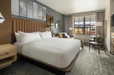 a hotel room with a large bed and a desk at Marriott's Timber Lodge in South Lake Tahoe