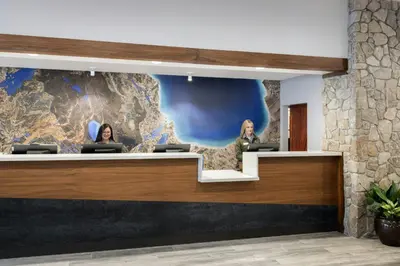a lobby with two women sitting at a counter at Marriott's Timber Lodge in South Lake Tahoe