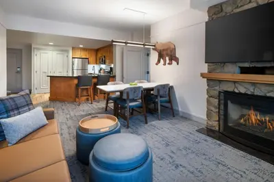 a living room with a table and a fireplace at Marriott's Timber Lodge in South Lake Tahoe