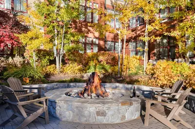 a fire pit in front of a building with two chairs at Marriott's Timber Lodge in South Lake Tahoe