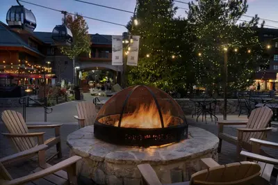a fire pit in a patio with chairs and tables at Marriott's Timber Lodge in South Lake Tahoe