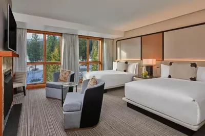 a hotel room with two beds and a flat screen tv at The Ritz-Carlton, Lake Tahoe in Truckee