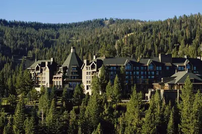a large building on a hill with trees at The Ritz-Carlton, Lake Tahoe in Truckee