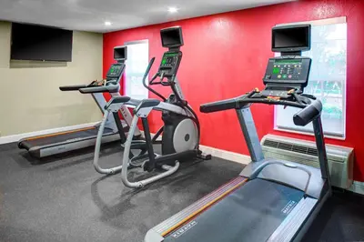 a gym with two treadmills and two treadleys at TownePlace Suites Fresno in Fresno