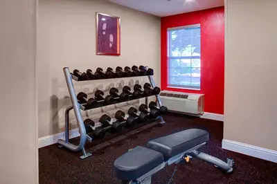 a gym with a rack of equipment in a room at TownePlace Suites Fresno in Fresno